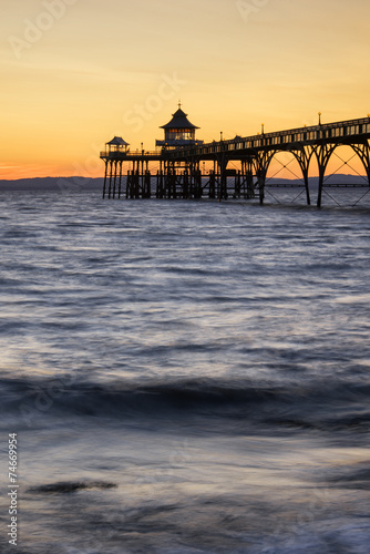 Beautiful long exposure sunset over ocean with pier silhouette © veneratio