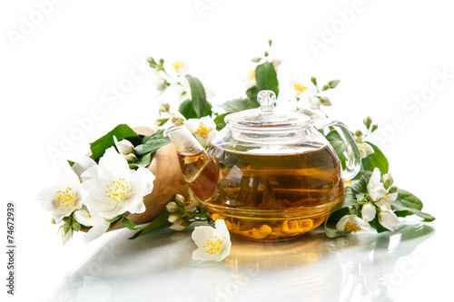 jasmine tea in a teapot with a branch of jasmine