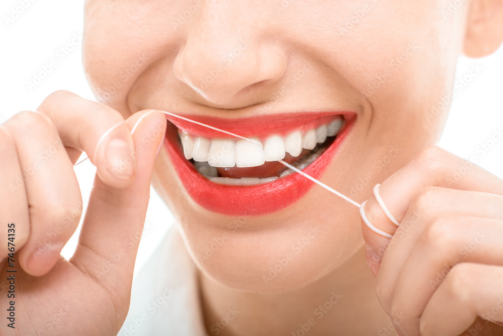 Naklejka premium Woman flossing teeth