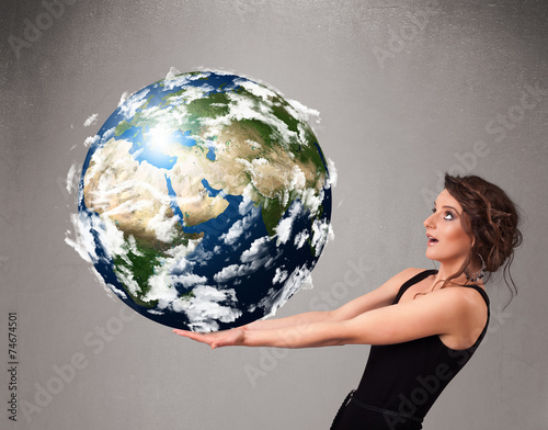 Pretty girl holding 3d planet earth photo