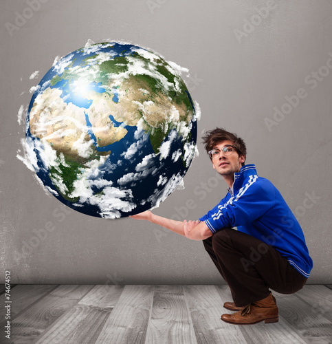 Good-looking man holding 3d planet earth photo