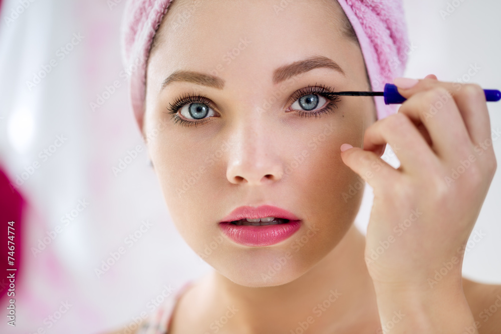 Close up of woman applying mascara