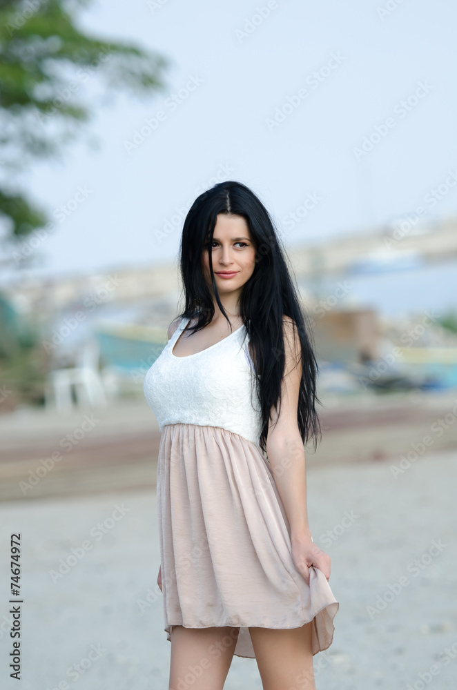 Woman in dress , fisherman in the background Woman in dress , fisherman in the background