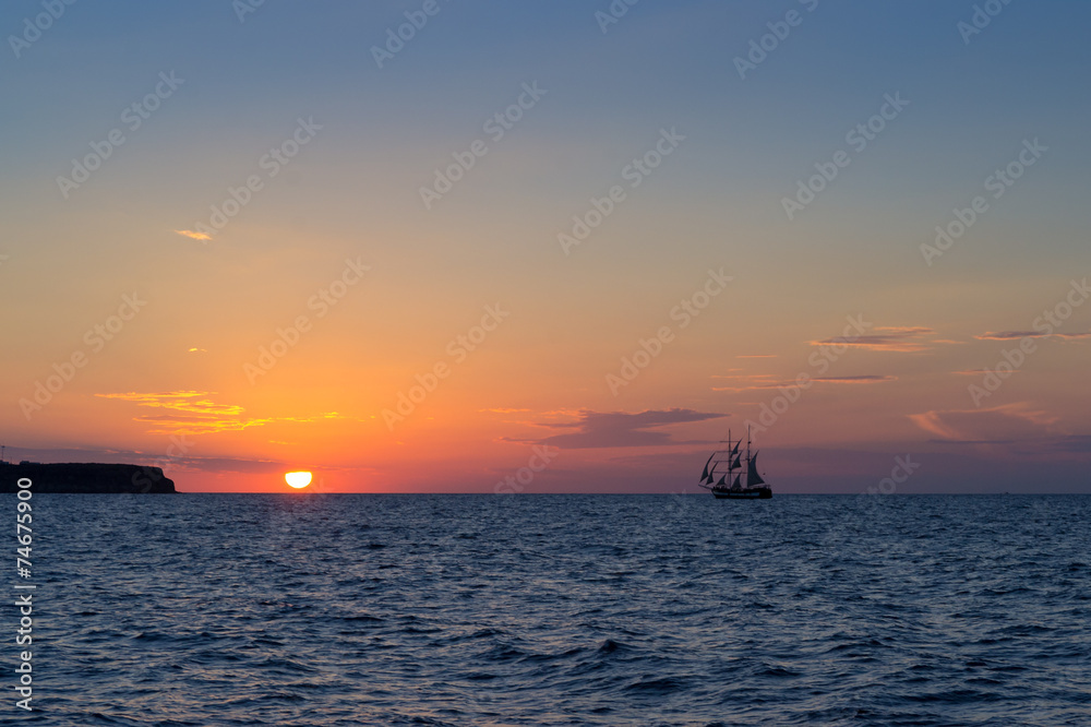 Sunset with sailing ship