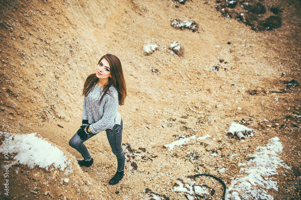 Fototapeta premium Pretty young woman outdoor in quarry with sand