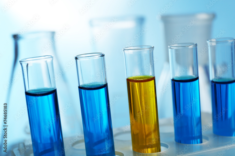Several test-tubes filled with colored fluid with flasks Several test-tubes filled with colored fluid with flasks