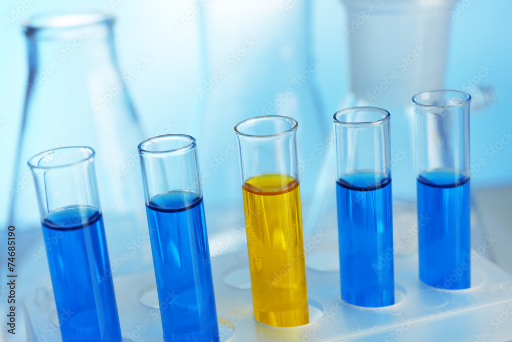 Several test-tubes filled with colored fluid with flasks Several test-tubes filled with colored fluid with flasks
