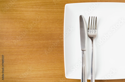 White place setting on a wooden table