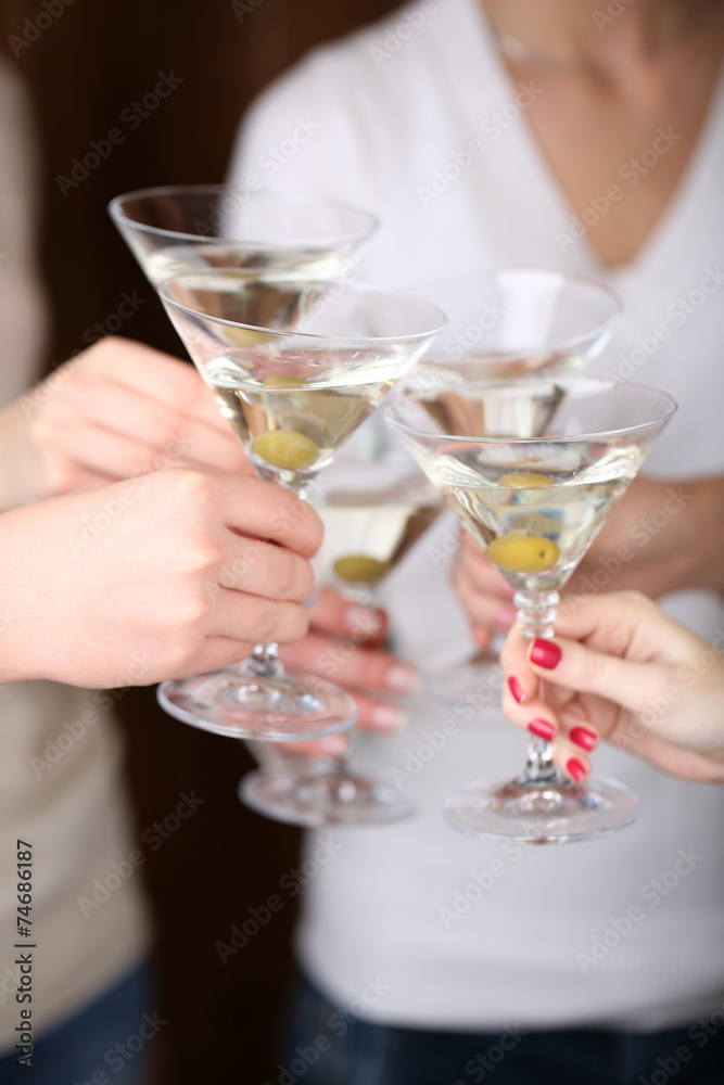 Woman hands with glasses of martini close-up