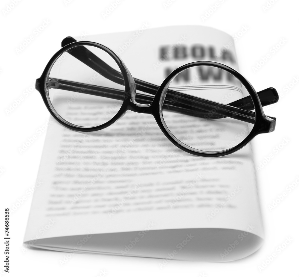 Glasses and newspapers, close-up Glasses and newspapers, close-up