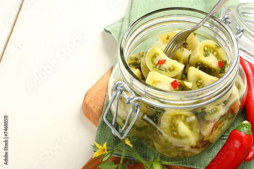 Homemade green tomatoes preserves in glass jar