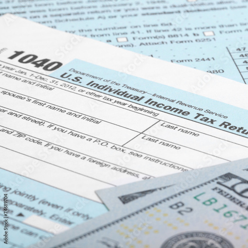 USA 1040 Tax Form with 100 US dollar bills