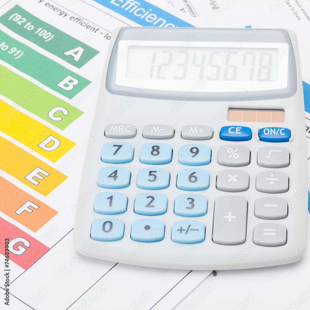 Calculator with energy efficiency chart - accounting concept Calculator with energy efficiency chart - accounting concept