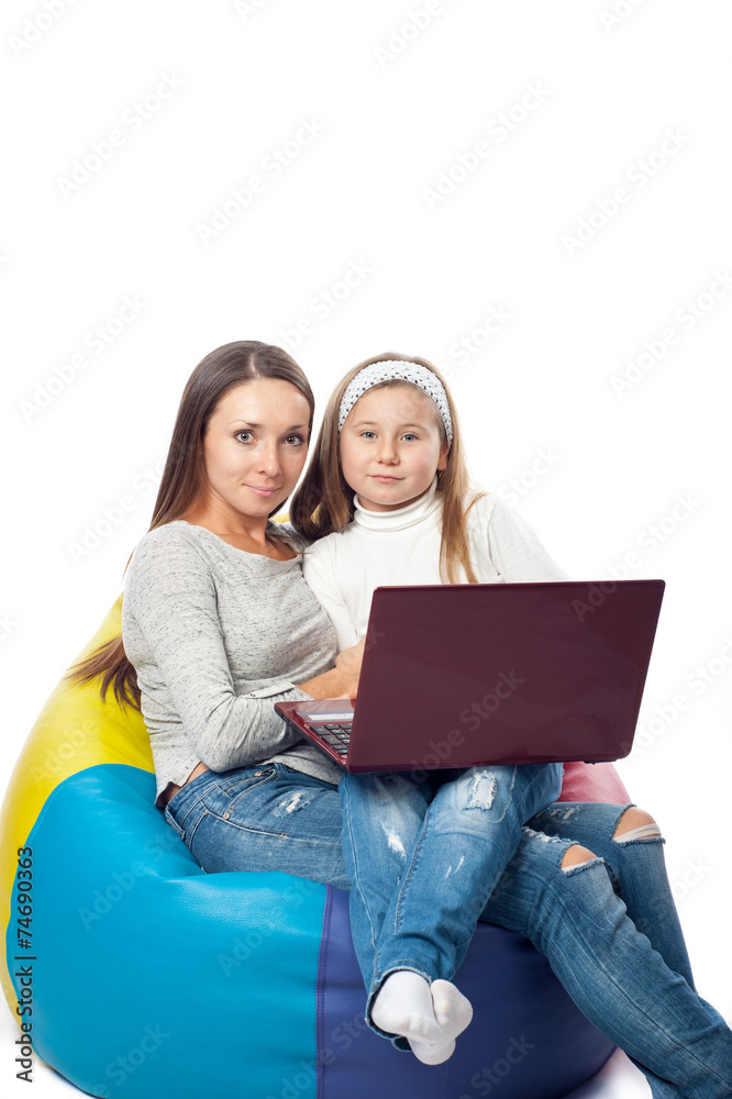 the girl with the woman in front of the computer