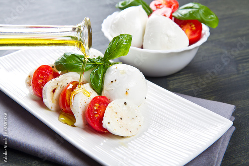 Tomato and mozzarella with basil leaves