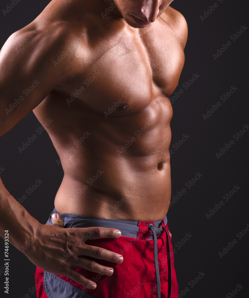 Naklejka premium Man with beautiful torso on black background