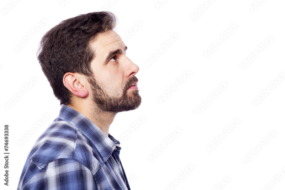 Side view of a pensive casual man looking up, isolated over whit Side view of a pensive casual man looking up, isolated over whit