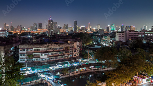 An aerial view of Bangkok city and old market along canal