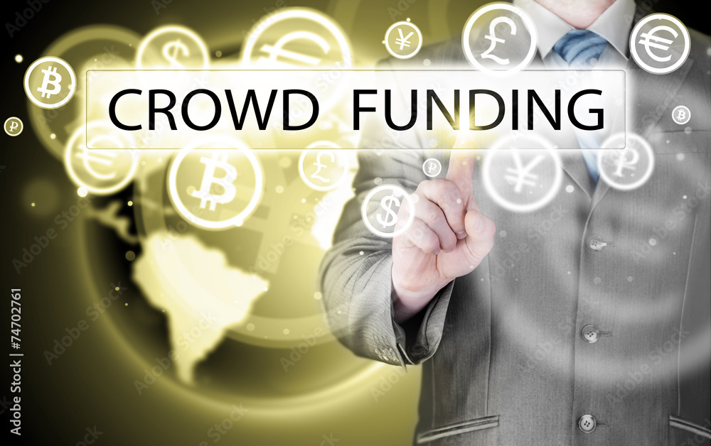 Businessman pushes virtual crowd funding button Businessman pushes virtual crowd funding button