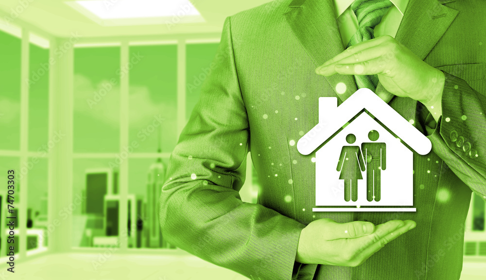 businessman protecting family in home with hands businessman protecting family in home with hands