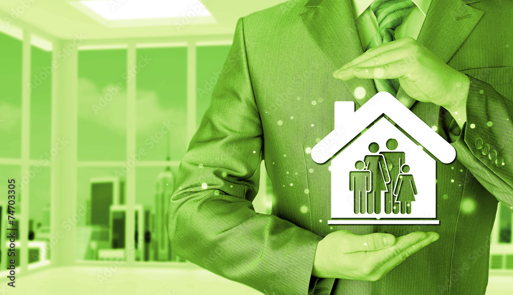 businessman protecting family in home with hands businessman protecting family in home with hands