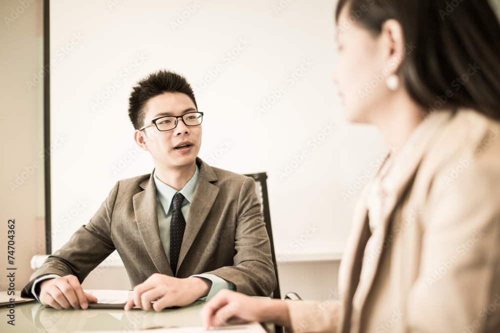 Successful young business executives meeting at the office Successful young business executives meeting at the office