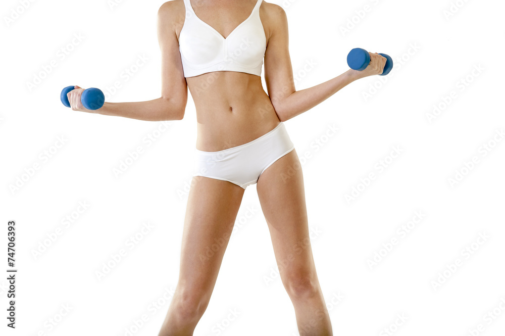 Young attractive woman exercising with pair of dumbbells Young attractive woman exercising with pair of dumbbells