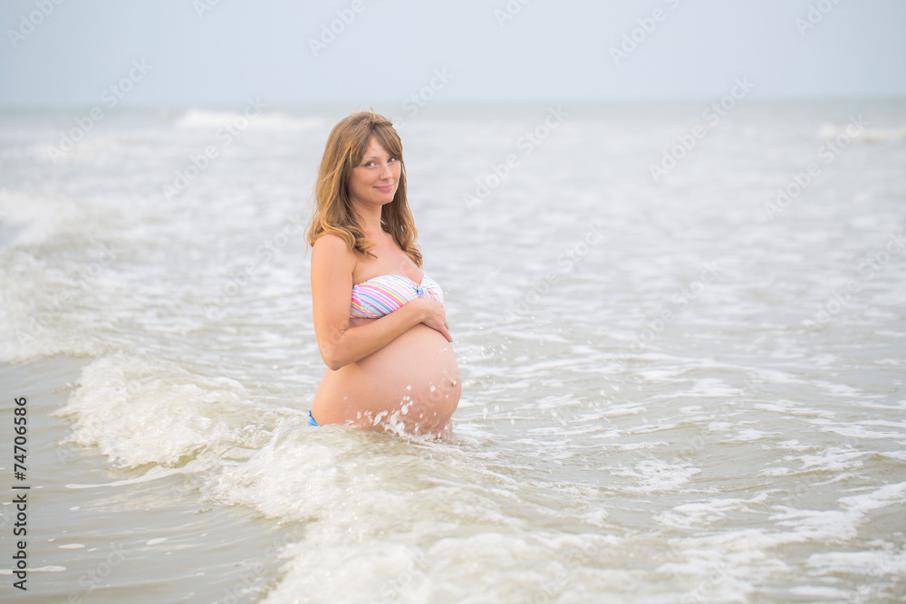 Fototapeta premium A pregnant woman on the beach