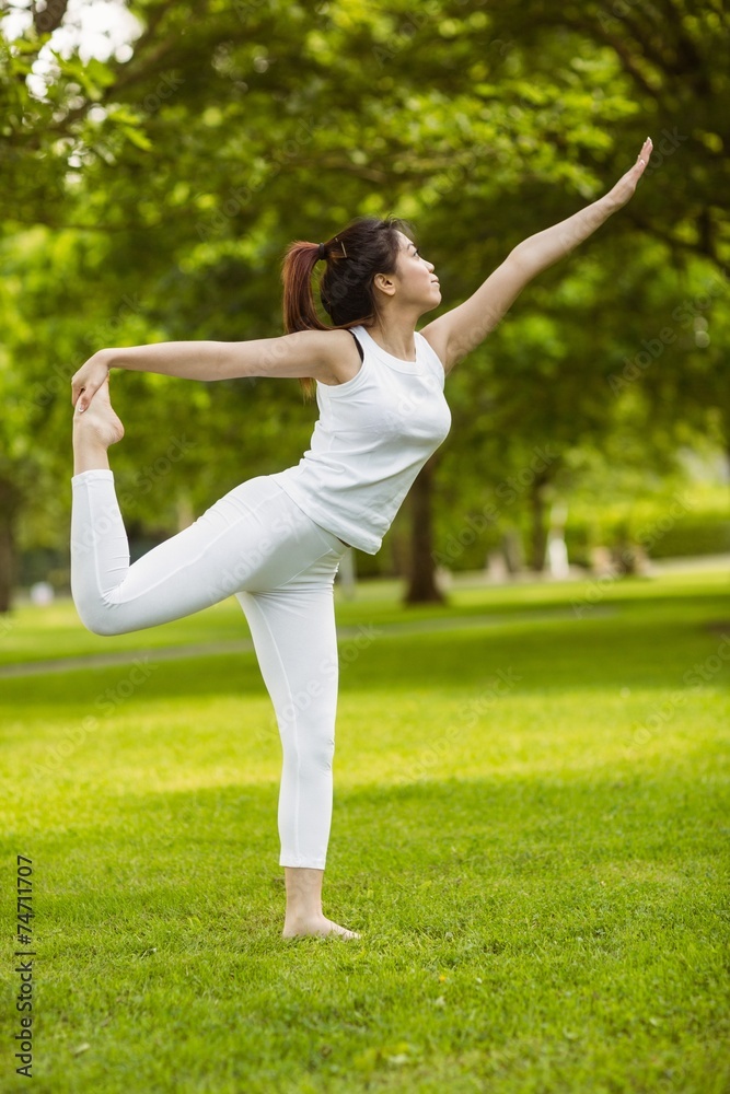 Toned woman doing stretching exercises in park Toned woman doing stretching exercises in park