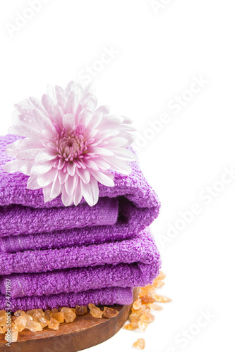 purple towels and chrysanthemum flower isolated on white.