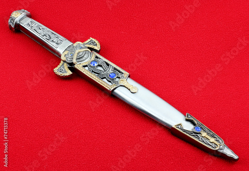 Fantasy style dagger on a red background.