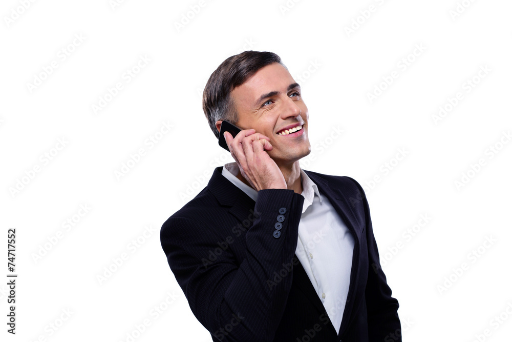 Happy businessman talking on the phone over white background Happy businessman talking on the phone over white background