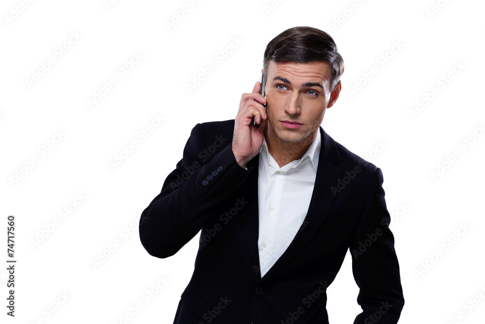 Serious businessman talking on the phone over white background Serious businessman talking on the phone over white background