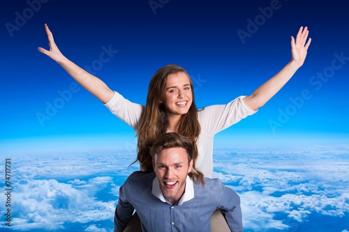 Composite image of smiling young man carrying woman