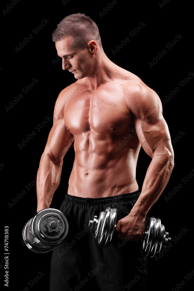 Muscular bodybuilder exercising with two weights