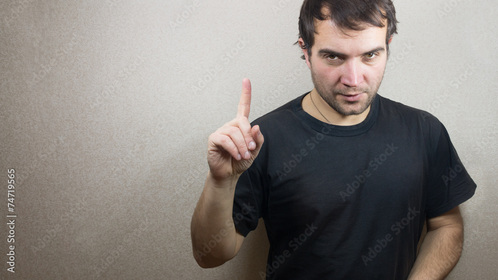 Man holding his index finger up by Man holding his index finger up by