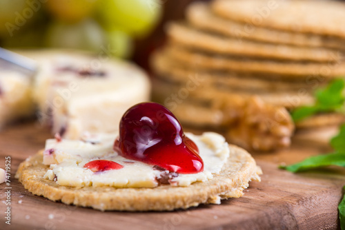 close view on oatcake with stilton cheese and cranberry sauce