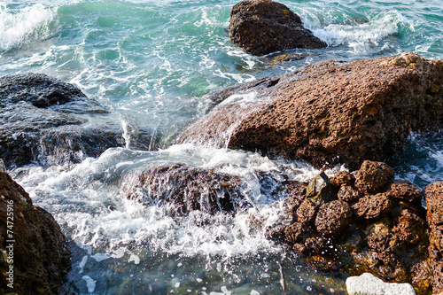 Sea waves rolling on stones