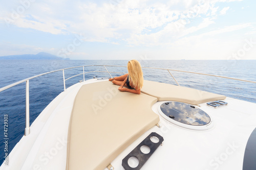 Young sexy woman enjoy on yacht at faraglioni island capri italy