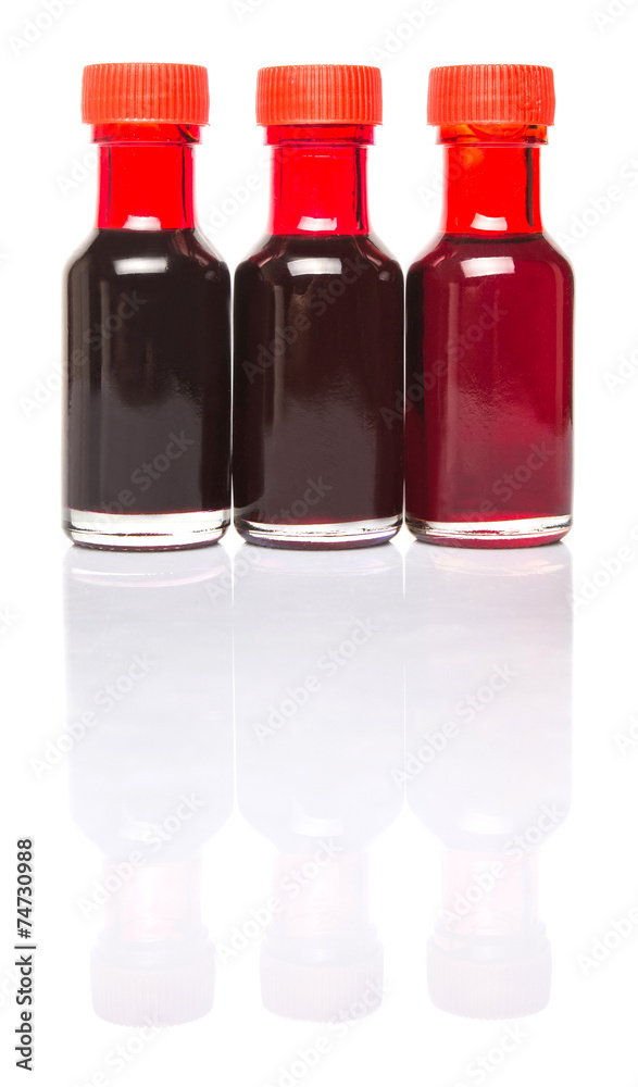 Liquid deep red food color additive over white background Liquid deep red food color additive over white background