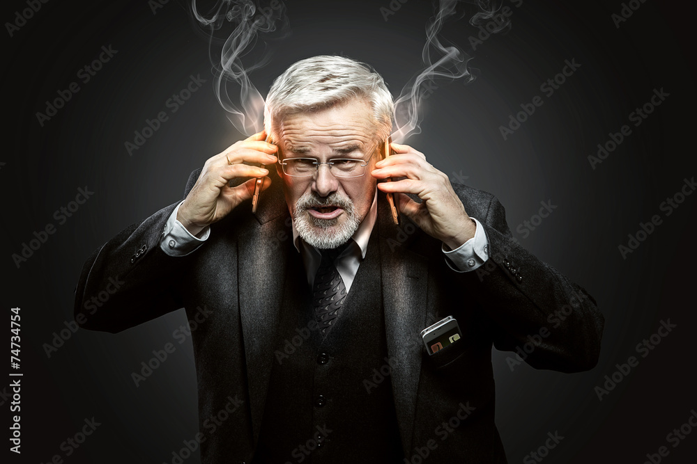 Businessman with burning Mobile Phones Businessman with burning Mobile Phones