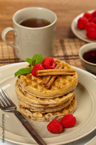 Waffles with raspberries and cinnamon. Selective focus.