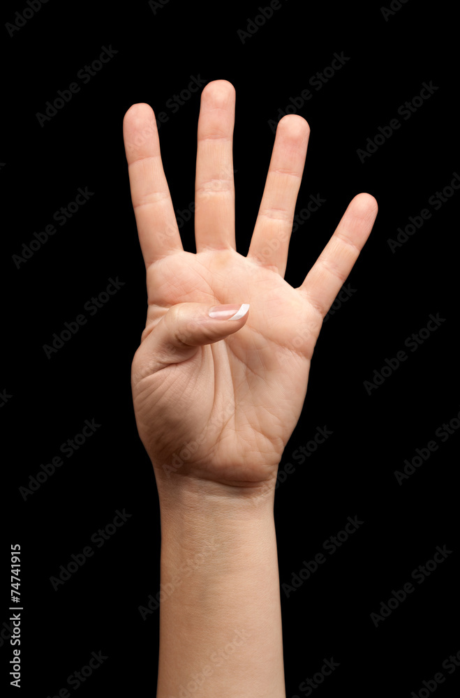 Female hand showing number four on a black background Female hand showing number four on a black background