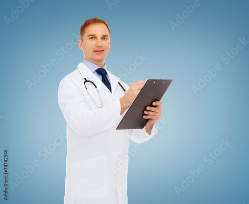 smiling male doctor with clipboard and stethoscope