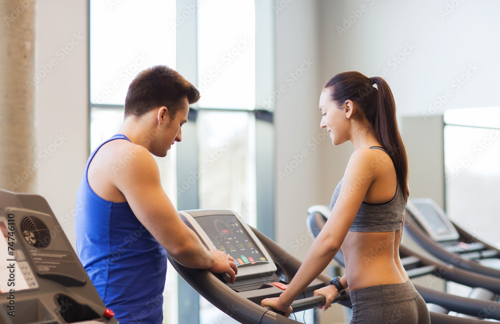 happy woman with trainer on treadmill in gym happy woman with trainer on treadmill in gym