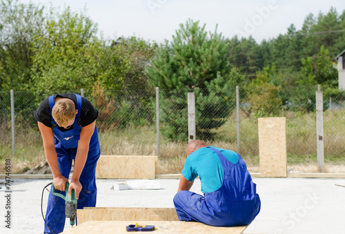 Two builders working on a building site