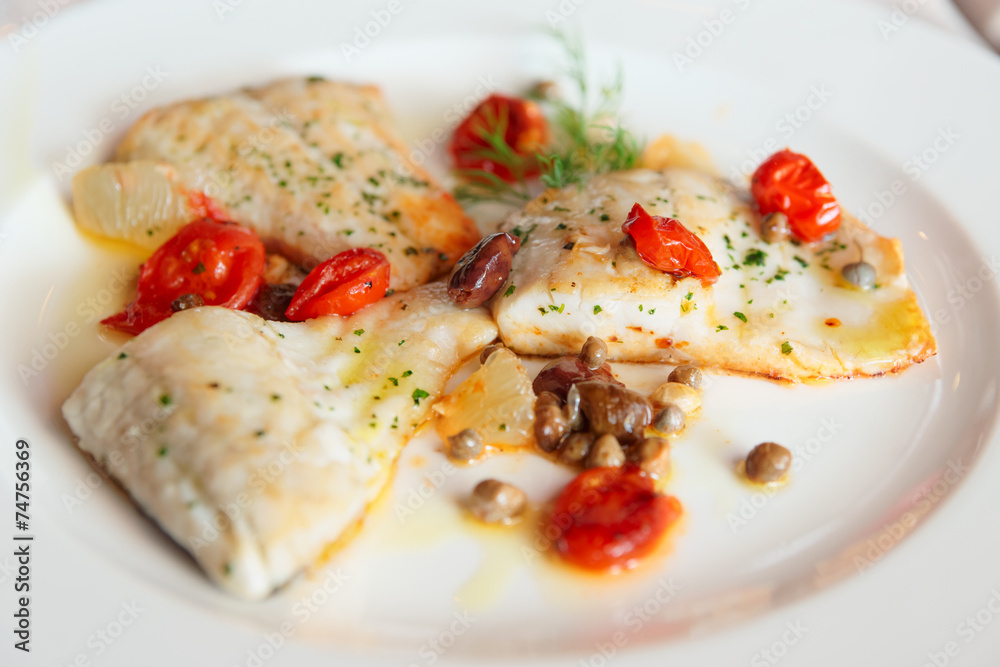 Fried fish fillet with capers and tomatoes