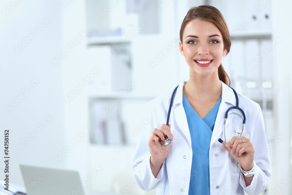 Portrait of happy successful young female doctor holding a