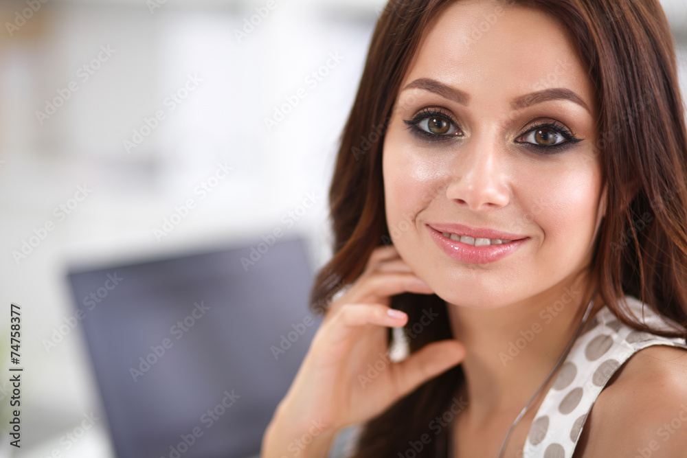 Attractive businesswoman sitting on desk in the office Attractive businesswoman sitting on desk in the office
