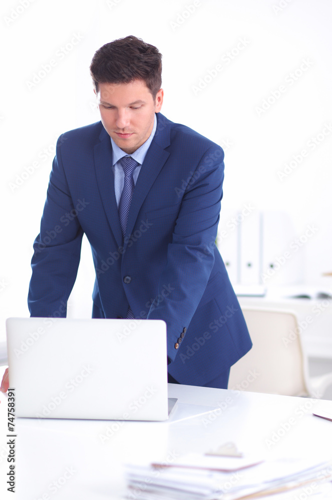 Confident successful young businessman leaning arms on his desk Confident successful young businessman leaning arms on his desk